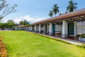 ein Gebäude mit grünem Rasen davor in der Unterkunft Elephyard Retreat in Mahiyangana