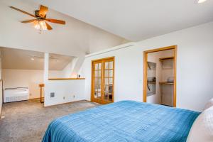 a bedroom with a blue bed and a ceiling fan at Tanglewood Retreat in Post Falls