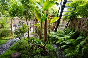 a garden with many plants and a staircase at Jungle Stay in a Hidden Paradise in Zwijndrecht