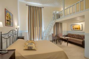 a bedroom with a bed and a living room at Omorfi Poli in Nafplio