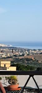 a view of a city from a balcony with a plant at B&B Gergent in Agrigento