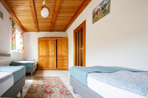 a bedroom with two beds and a wooden ceiling at Holiday home Jarzębinowa 9 in Rowy