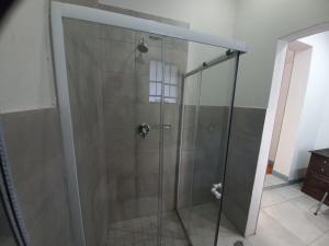 a shower with a glass door in a bathroom at Triple9 Hatfield Guesthouse in Pretoria
