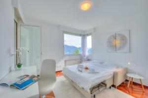 Postel nebo postele na pokoji v ubytování Residenza Parco Carona - Happy Rentals