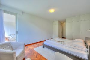 Postel nebo postele na pokoji v ubytování Residenza Parco Carona - Happy Rentals