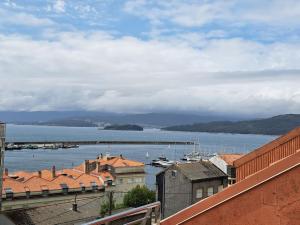 a view of a body of water with houses and buildings at Casa Antonia Portosín in Portosin