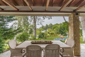 een patio met een tafel en stoelen bij #Calypso by halu! Sani Villas in Sani Beach