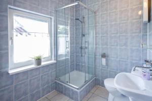 a bathroom with a shower and a toilet and a sink at Holiday home Jarzębinowa 9 in Rowy +33 photos