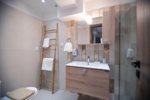 a bathroom with a sink and a toilet at Niki Athens Suites - Cosy Suite in the historical center of Athens in Athens