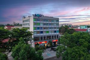 a large building with a sign on top of it at SOJO HOTEL DAK LAK in Buon Ma Thuot