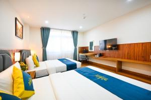 Postel nebo postele na pokoji v ubytování PLUS VUNG TAU HOTEL