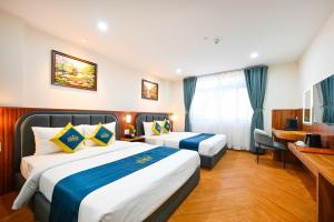 Postel nebo postele na pokoji v ubytování PLUS VUNG TAU HOTEL