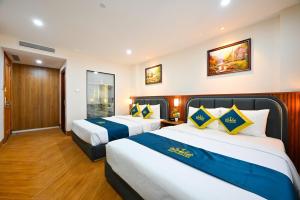 Postel nebo postele na pokoji v ubytování PLUS VUNG TAU HOTEL