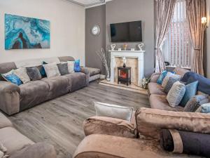 a living room with couches and a fireplace at The Ascot in Blackpool