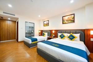 Postel nebo postele na pokoji v ubytování PLUS VUNG TAU HOTEL