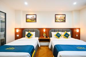 Postel nebo postele na pokoji v ubytování PLUS VUNG TAU HOTEL