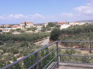 a view of a town from the top of a metal railing at Olivenhainhaus / Eleonas in Asopós