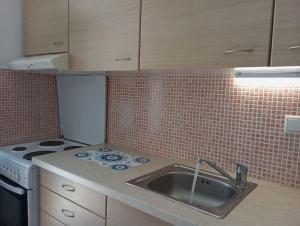 a kitchen with a sink and a stove at Seaside Nicola's Studio in Matala