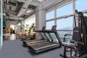 a gym with tread machines and a view of the city at Pagoda Hotel Shenzhen in Shenzhen