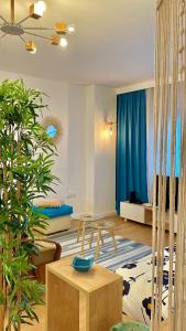 a living room with a table and some plants at Studio Flat in the City Center in Tirana