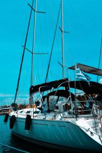 a sailboat docked in a harbor on the water at Godspeed in Thessaloniki