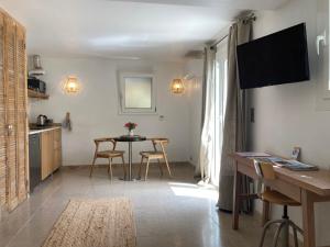 a kitchen with a table and chairs in a room at Castel'lodge in Le Beausset