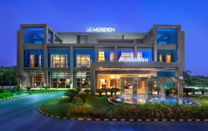a rendering of a modern building at night at Le Meridien Nagpur in Nagpur