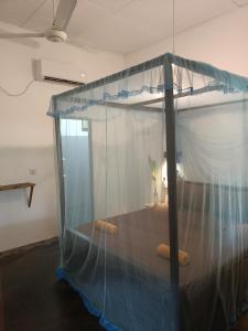 ein Himmelbett mit zwei Kissen in einem Zimmer in der Unterkunft Ocean Bliss in Pottuvil