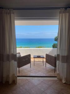 a living room with a view of the ocean at Villa Belinda in Santa Margherita di Pula