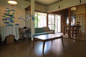 a living room with a couch and a table at Guest house Matsuo 