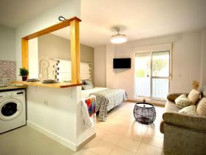 a kitchen and living room with a bed and a couch at MyChoice Alegria in Rota