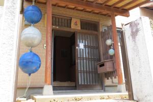 two blue balloons are hanging outside of a building at Guest house Matsuo 