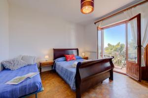 Postel nebo postele na pokoji v ubytování Residenza Il Parco Family Retreat - Happy Rentals + 26 fotografií