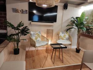 a living room with two chairs and a table at Hotel Mariquito in Finisterre