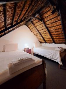 a bedroom with two beds in a attic at Hebron Haven Hotel in Dargle
