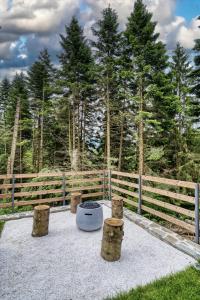 a group of logs sitting in front of a fence at Norway Cabins - Private Terrace & Fire Pit in Sinaia