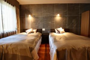 Postel nebo postele na pokoji v ubytování Hakuba Park Hotel