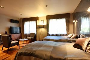 Postel nebo postele na pokoji v ubytování Hakuba Park Hotel