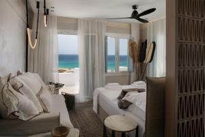 アギオス・プロコピオスにあるSea U Soon Seafront Suitesのベッドがあり海が見える寝室