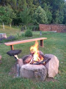 a bench sitting on top of a fire pit at Oak apartment in Březnice