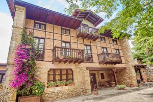 a large building with balconies and flowers on it at Casona los Cautivos in Oreña