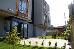 a house with a courtyard in front of it at KUZEY OTEL in Sinop