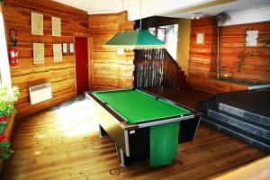 a pool table in a room with wooden walls at appartement 6 personnes proche commerce et remontés mécaniques in Saint-Lary-Soulan