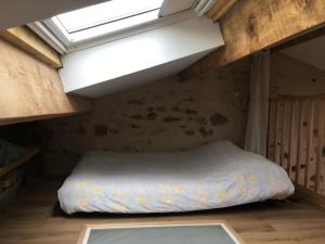 a bedroom with a bed in a room with a window at Loft Sud-Nantes in Le Bignon