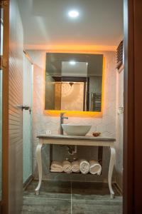 a bathroom with a sink and a mirror at La Vie Konak Otel in Eskisehir