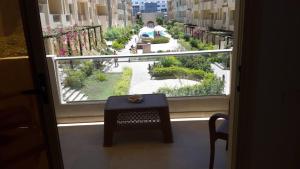 a window with a table and a view of a courtyard at casa di nonna in Hurghada +3 photos