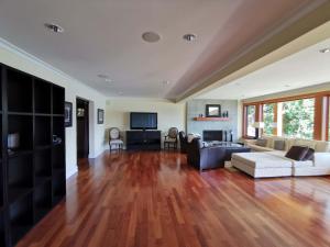 a living room with a couch and a table at Deep Cove Stunning Waterfront Whole House in North Vancouver