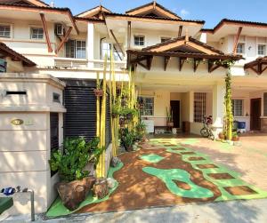 a house with a golf course painted on the front yard at Putrajaya Transit Romestay in Putrajaya