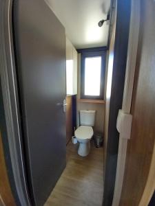 a small bathroom with a toilet and a window at Bruse & Costa à la montagne 2 in Chorges +13 photos