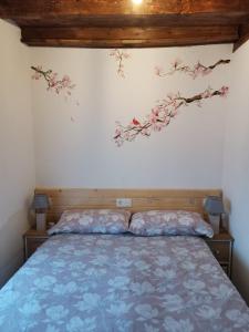 um quarto com uma cama com flores na parede em CASA SANTIBAÑEZ DE LA FUENTE 